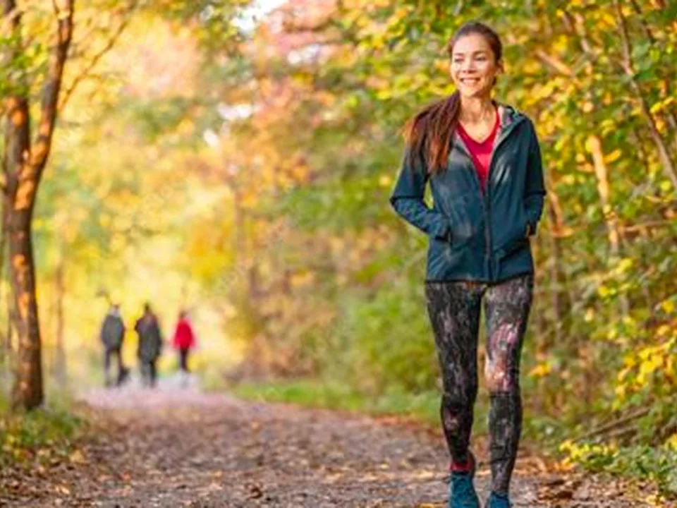 Woman walking through calm nature path